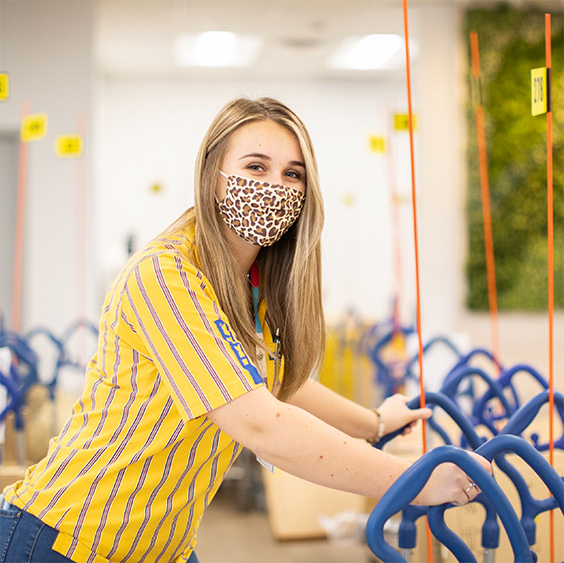 Happy IKEA employee wearing a mask for protection