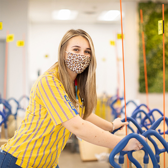 Happy IKEA employee wearing a mask for protection